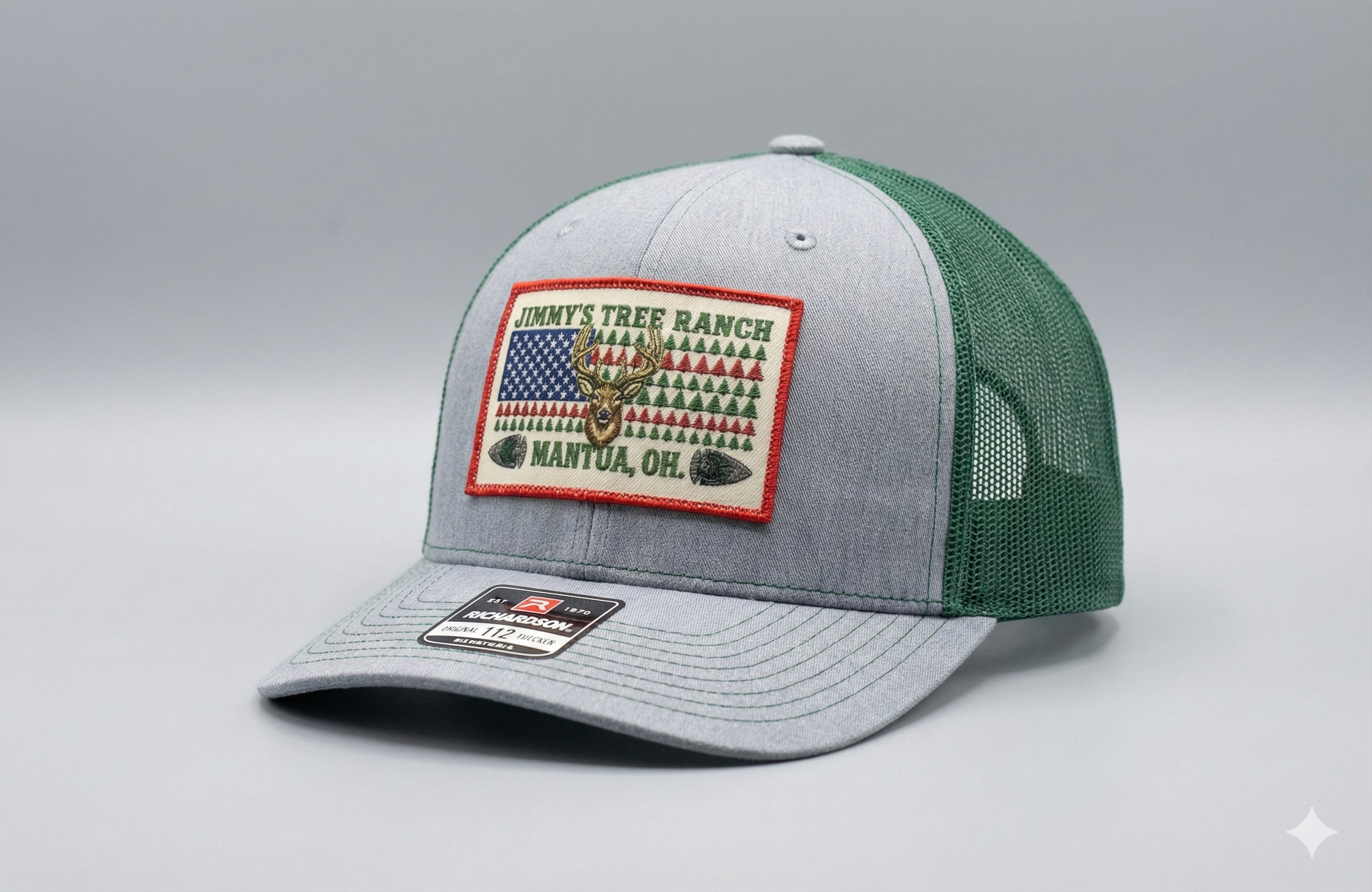Gray and green cap with embroidered color patch on a gray hat background